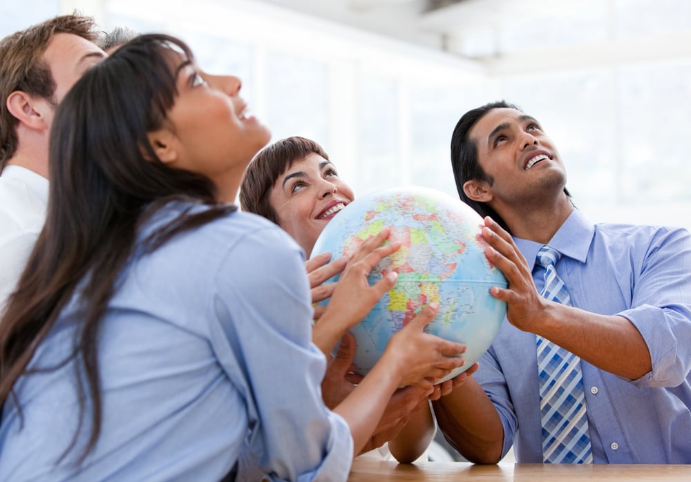 International business team holding a terrestrial globe in a meeting
