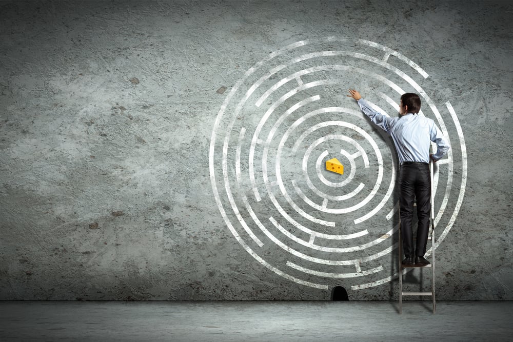 Image of businessman standing on ladder against maze picture